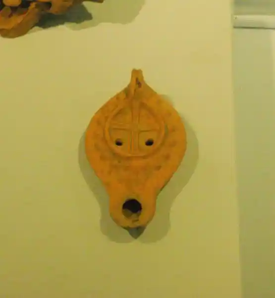 Solar cross on embossed sheets, during the Byzantine period. There are two holes on the cross and also a mouth at the bottom.